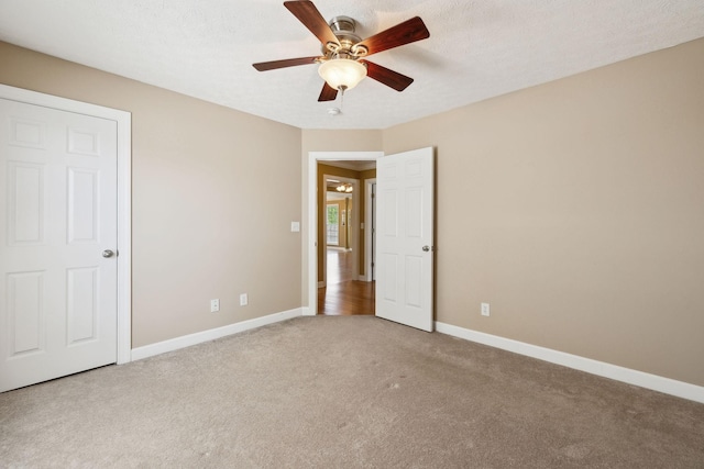 unfurnished bedroom featuring ceiling fan, baseboards, and carpet floors