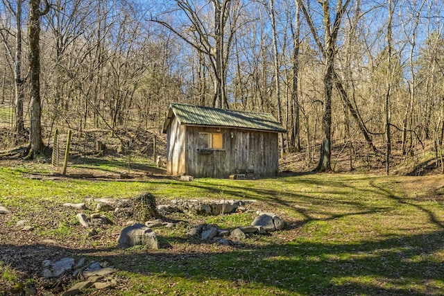 view of shed featuring a view of trees