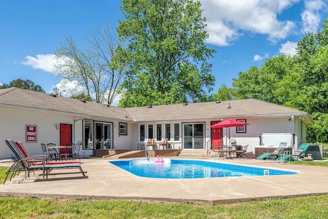 back of house featuring a patio area and an outdoor pool