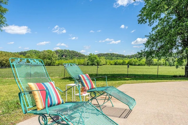 view of patio / terrace featuring a view of trees