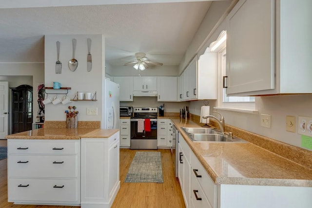 kitchen with appliances with stainless steel finishes, a sink, white cabinetry, and under cabinet range hood