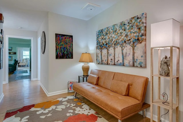 living area featuring wood finished floors and baseboards