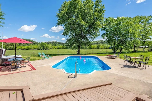 view of swimming pool with a fenced in pool, a patio area, a lawn, and a fenced backyard