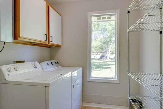 clothes washing area with cabinet space and washer and clothes dryer