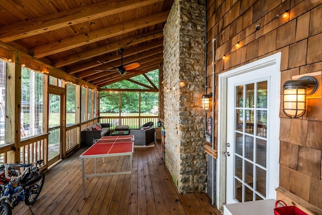 unfurnished sunroom with vaulted ceiling with beams, wood ceiling, and ceiling fan