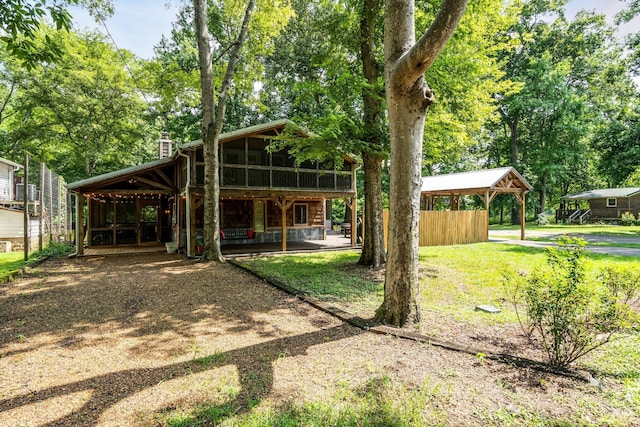 exterior space with a patio, a front lawn, a chimney, and a sunroom