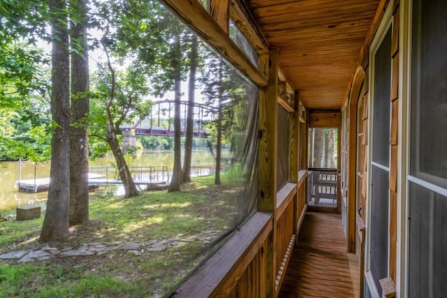 unfurnished sunroom with wood ceiling