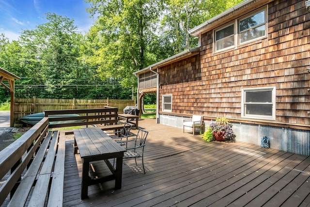 wooden terrace featuring fence and outdoor dining area