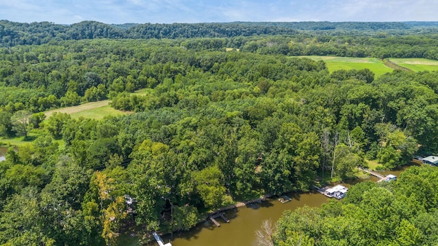 aerial view with a water view and a forest view