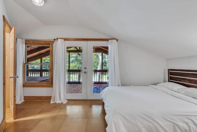 tiled bedroom with access to outside, french doors, and lofted ceiling