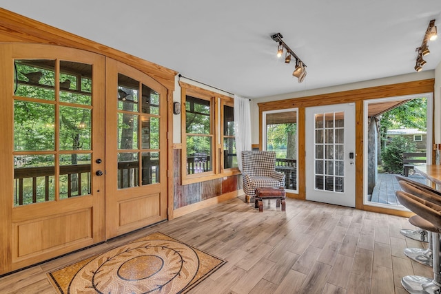 entryway featuring wood finished floors and track lighting