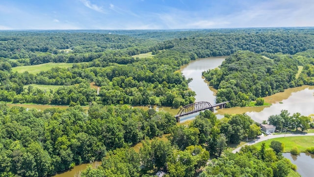 aerial view featuring a water view and a wooded view