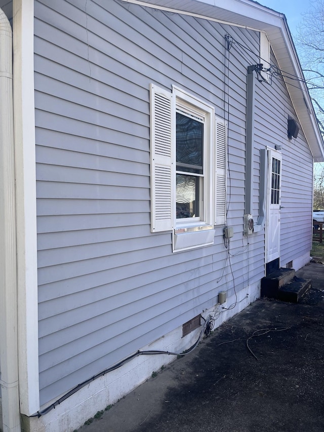 view of side of property with crawl space and entry steps