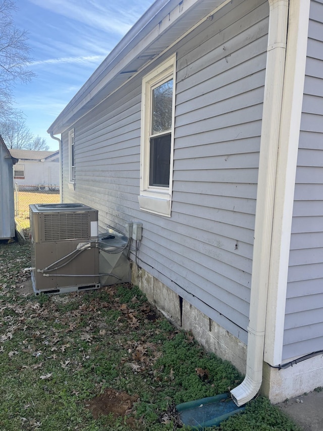 view of side of property featuring central AC