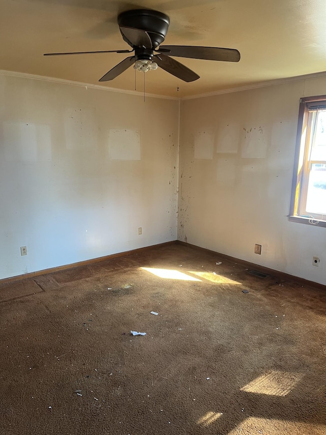 empty room featuring crown molding, baseboards, and ceiling fan