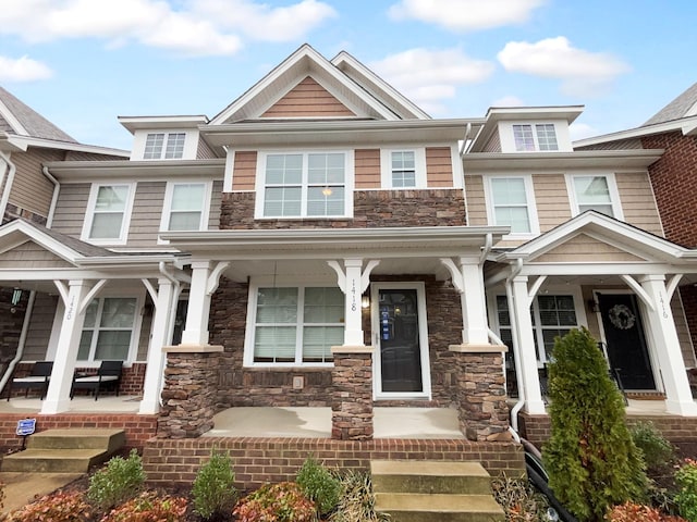 view of front facade featuring covered porch and stone siding