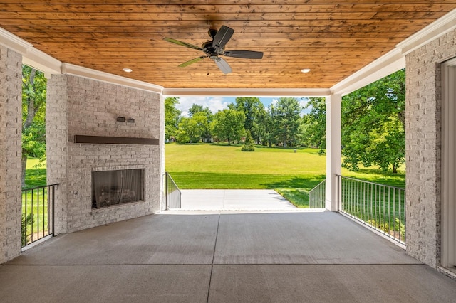 view of patio / terrace with an outdoor brick fireplace and ceiling fan