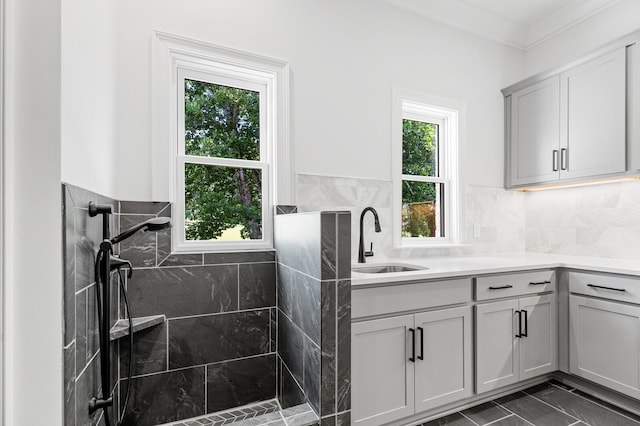 full bath with a tile shower and vanity