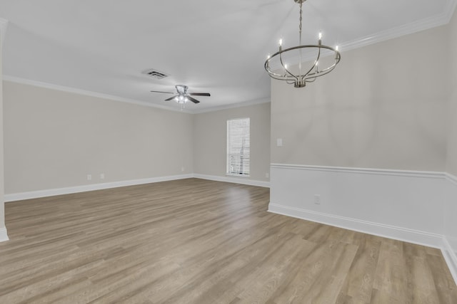 spare room with baseboards, crown molding, light wood finished floors, and ceiling fan with notable chandelier