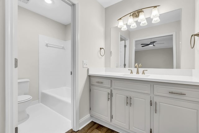 bathroom with visible vents, toilet, a ceiling fan, vanity, and baseboards