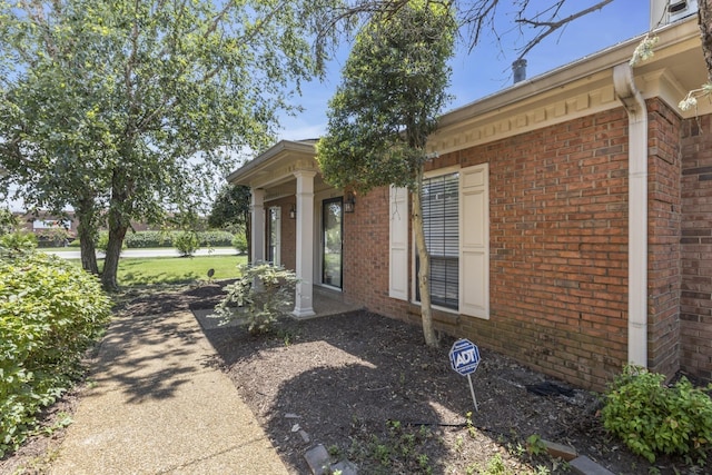 exterior space featuring brick siding