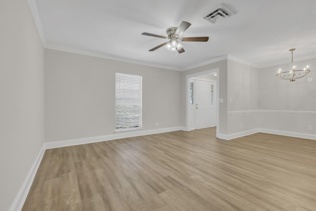 spare room with light wood finished floors, visible vents, and baseboards