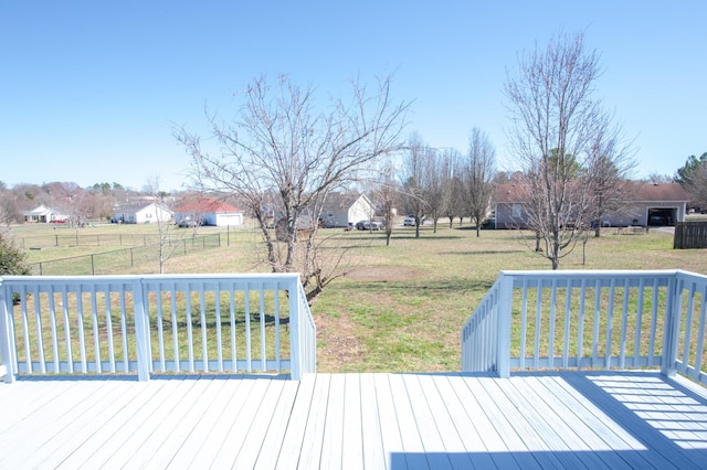 wooden deck with fence and a lawn