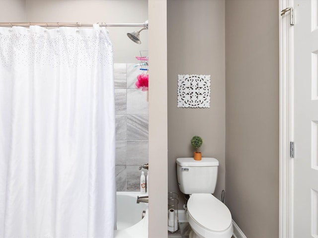 bathroom with toilet and shower / tub combo with curtain