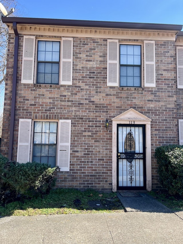 townhome / multi-family property featuring brick siding