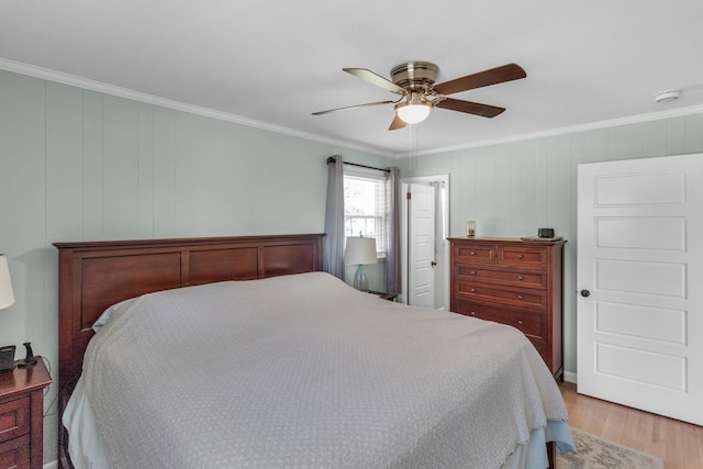 bedroom featuring ornamental molding, ceiling fan, and light wood finished floors