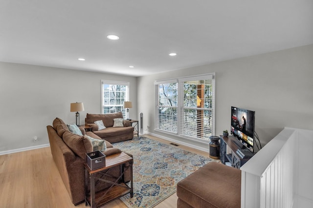 living area featuring baseboards, wood finished floors, visible vents, and recessed lighting