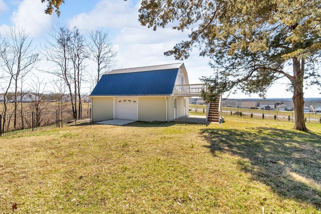 exterior space featuring an outbuilding, fence, a deck, and stairs