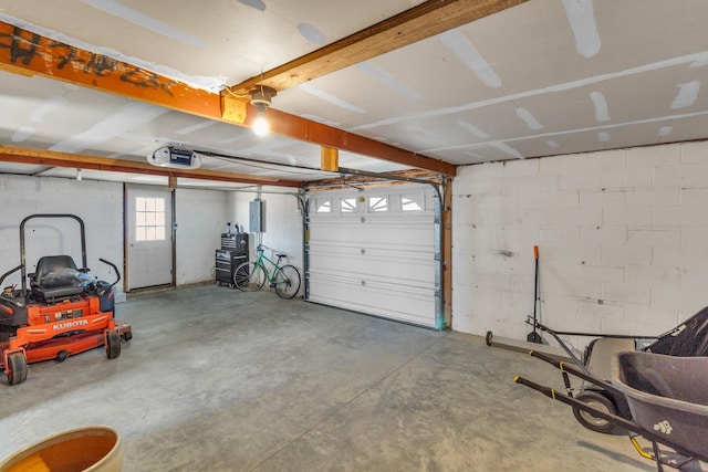 garage featuring electric panel and a garage door opener