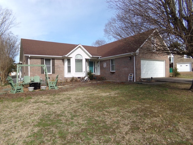 single story home featuring brick siding, a front lawn, an attached garage, and aphalt driveway