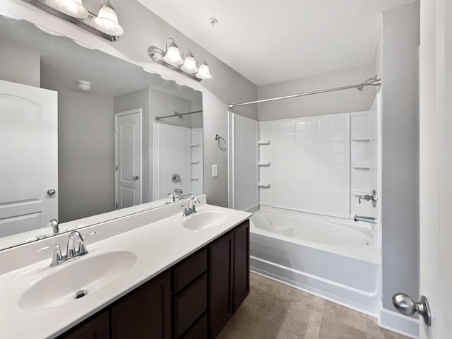 bathroom featuring bathtub / shower combination, a sink, and double vanity