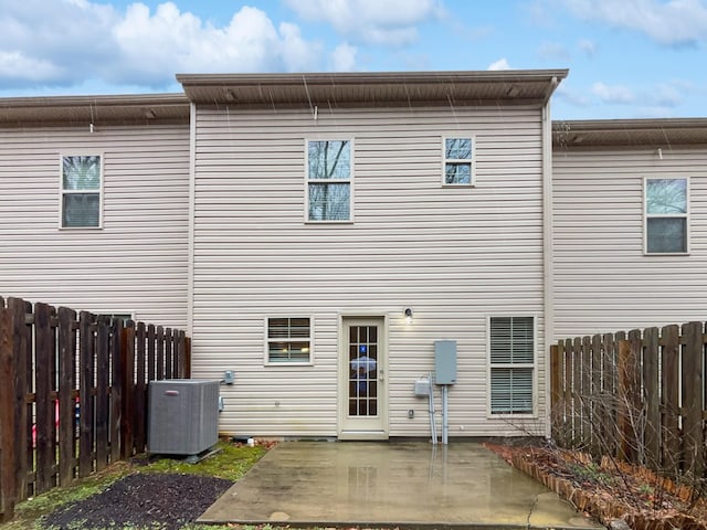 back of property with a patio area, cooling unit, and fence