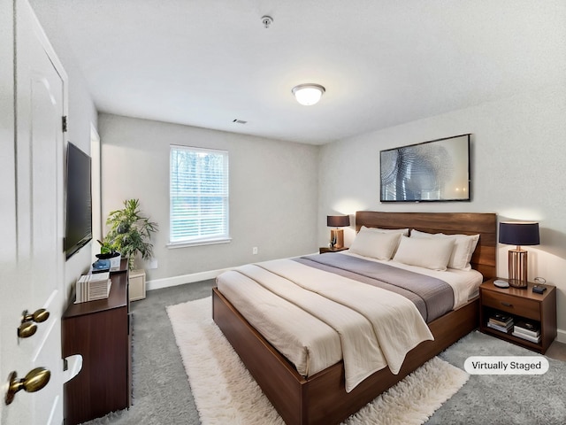 bedroom featuring carpet and baseboards