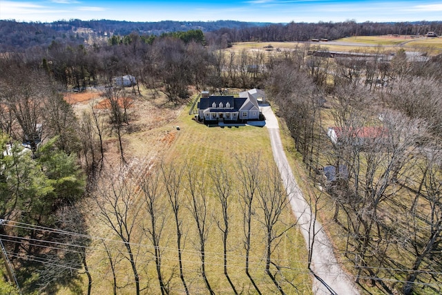 drone / aerial view featuring a wooded view