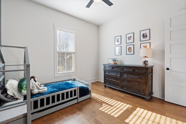 bedroom featuring a ceiling fan and wood finished floors