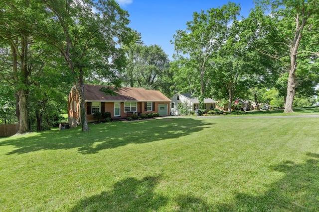 view of front of house featuring a front lawn and brick siding