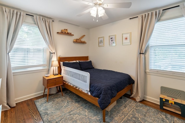 bedroom featuring wood finished floors, a ceiling fan, and baseboards