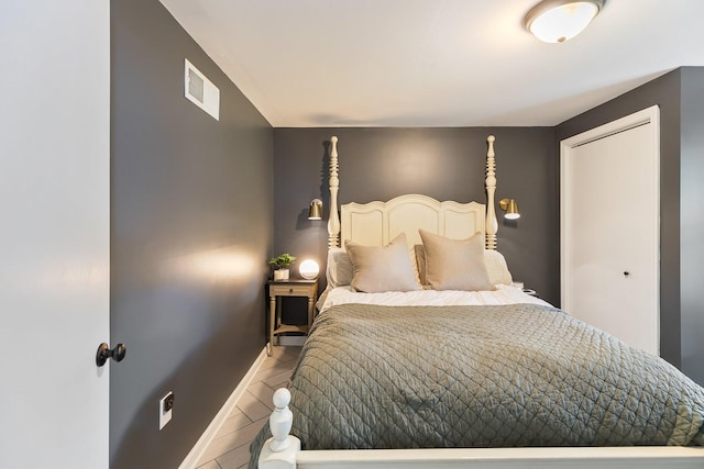 bedroom featuring baseboards and visible vents