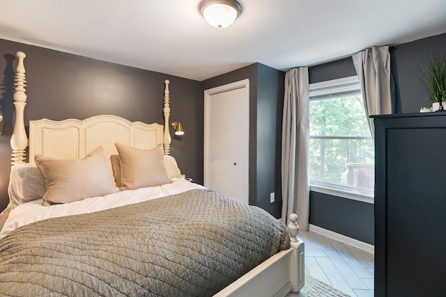 bedroom with baseboards and a closet