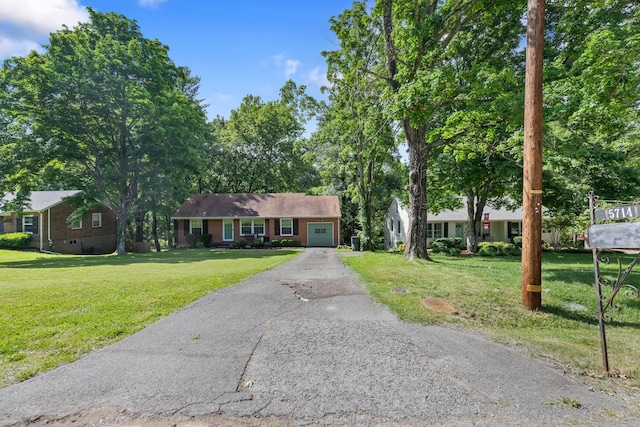 ranch-style home with a garage, a front yard, and driveway