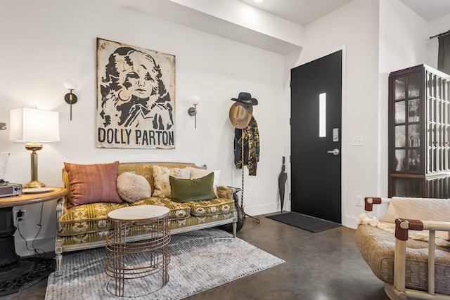 entrance foyer featuring baseboards and finished concrete floors