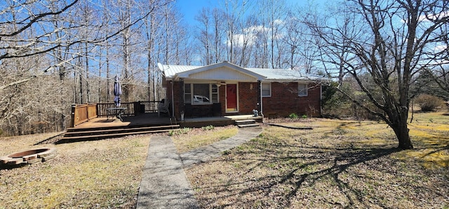 view of front of house featuring brick siding and metal roof