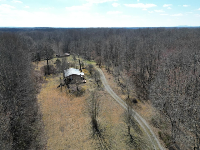 bird's eye view featuring a view of trees and a rural view