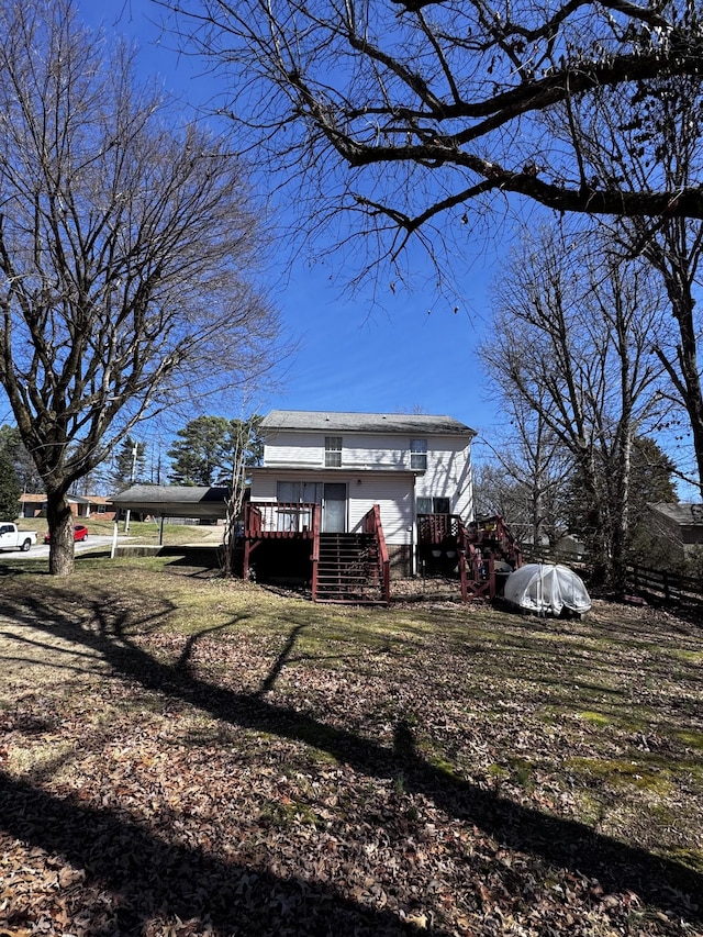 view of front of house featuring a carport and a wooden deck