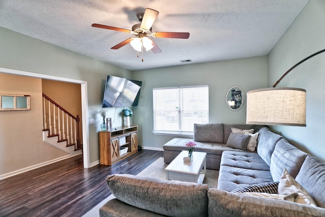 living room with baseboards, visible vents, a ceiling fan, stairway, and wood finished floors