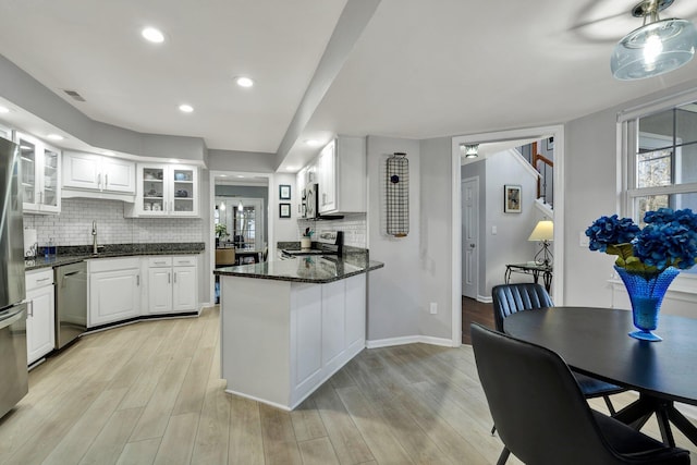 kitchen with appliances with stainless steel finishes, light wood-style flooring, and white cabinetry